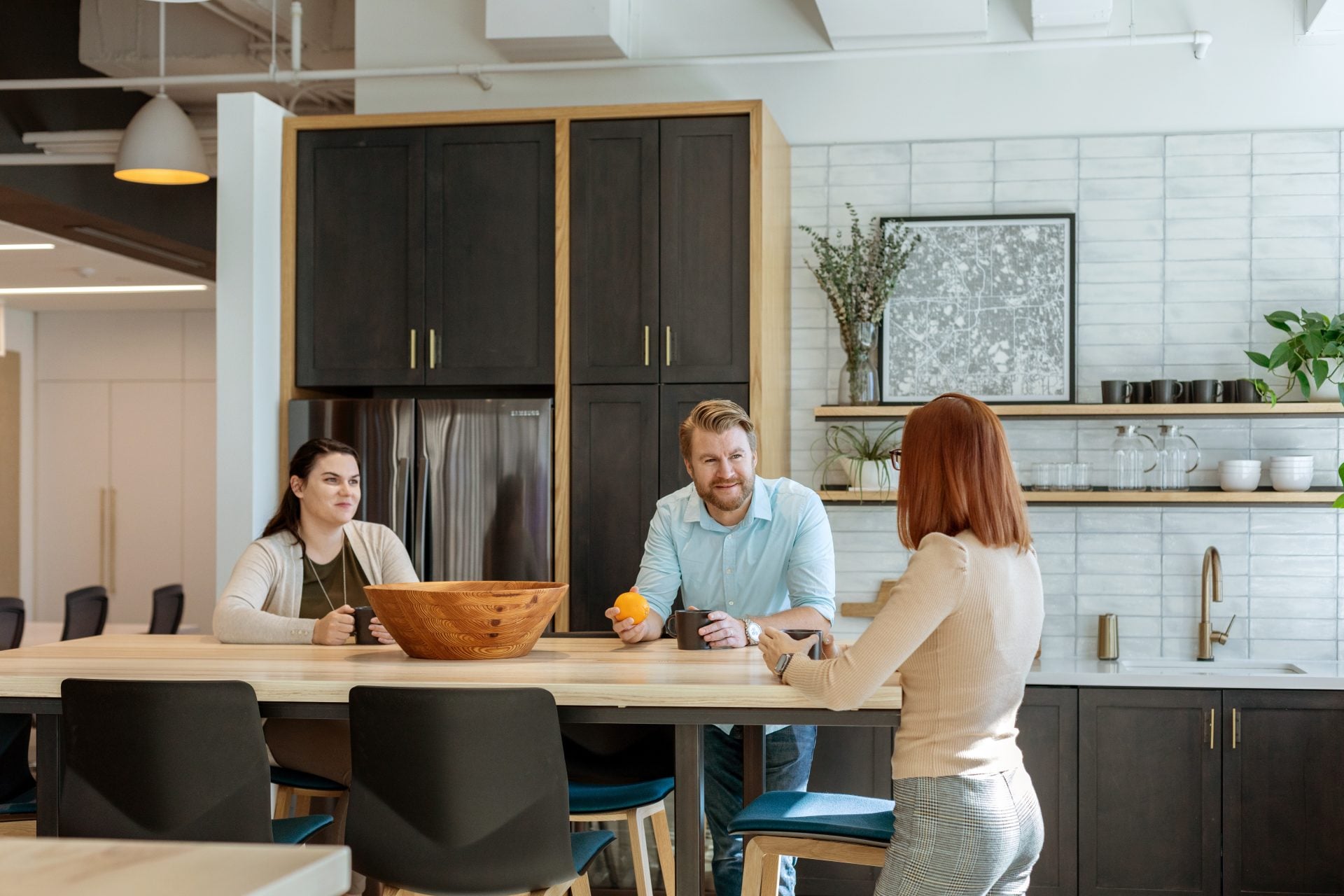 Photograph of people meeting in kitchen area