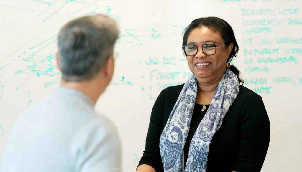 People meeting in front of whiteboard